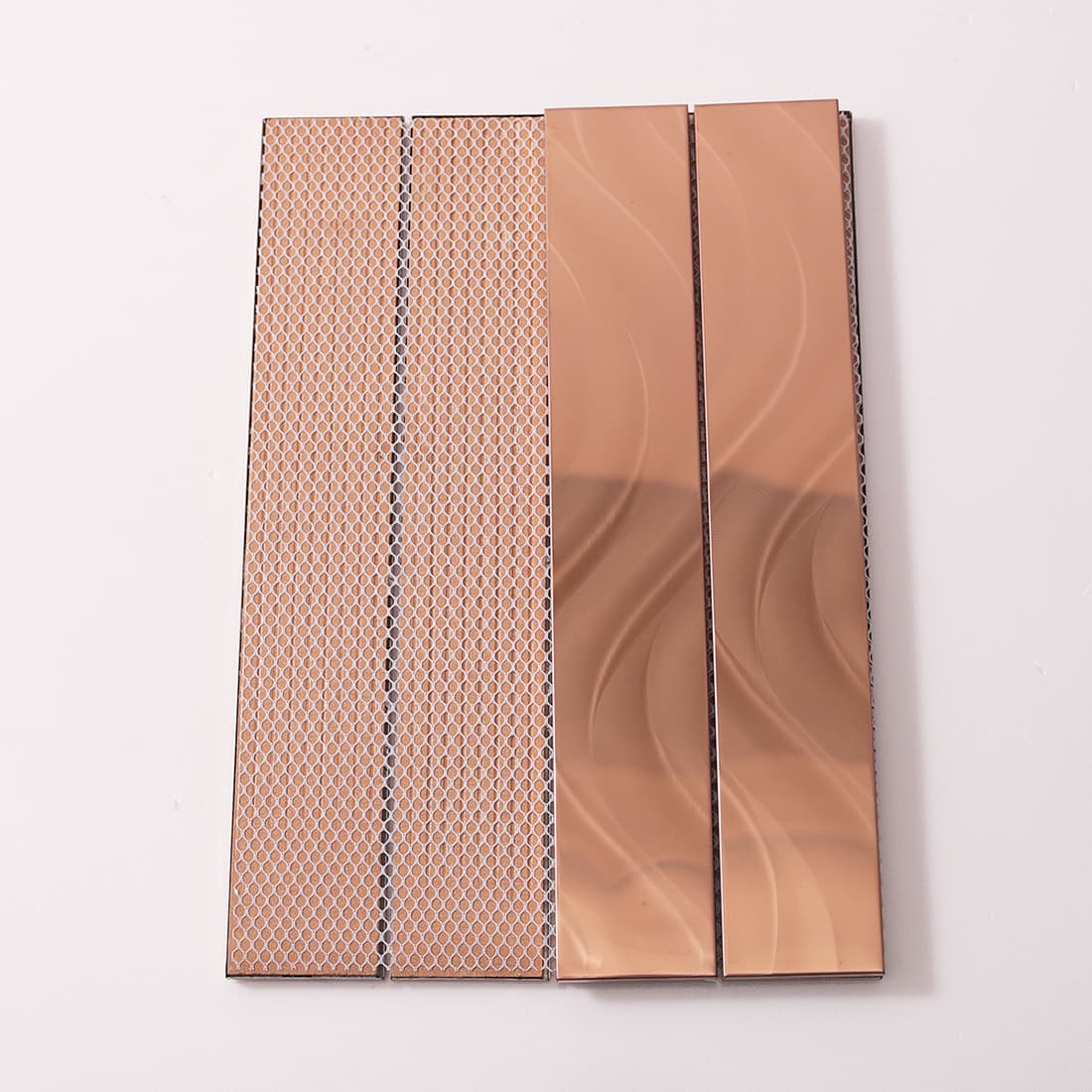 Front and back of rose gold flowy tiles showing the mesh installation backing.