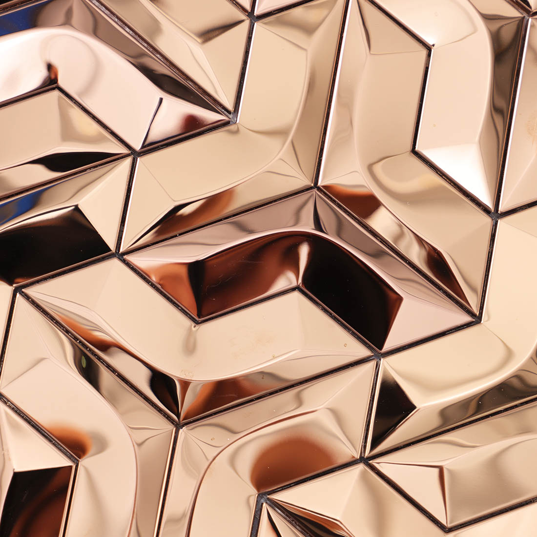 Surface texture detail of rose gold geometric 3D metallic mosaic