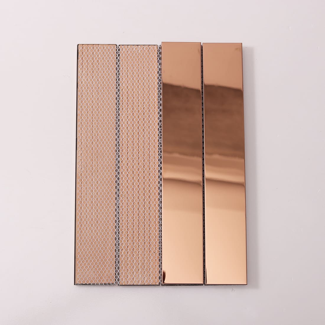 Front and back of rose gold linear tile showing the mesh installation backing.