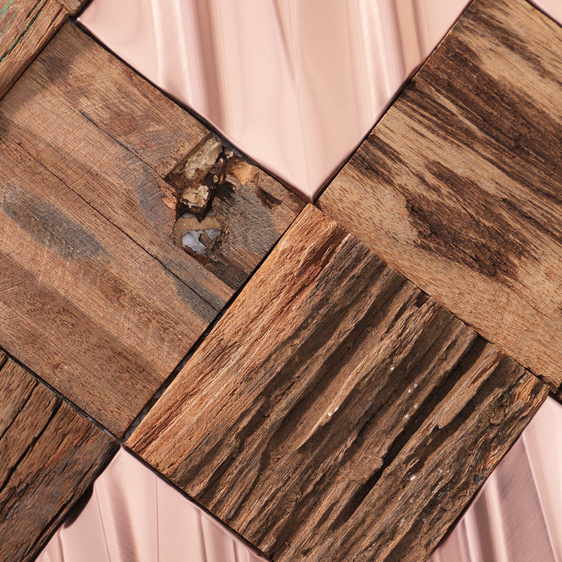Detailed view of rose gold metal and rustic wood mosaic tile textures