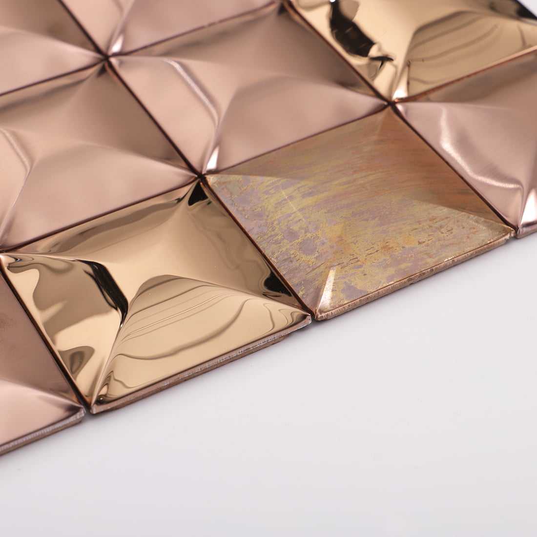 Edge view of rose gold mixed metal square 3D mosaic tile sheet