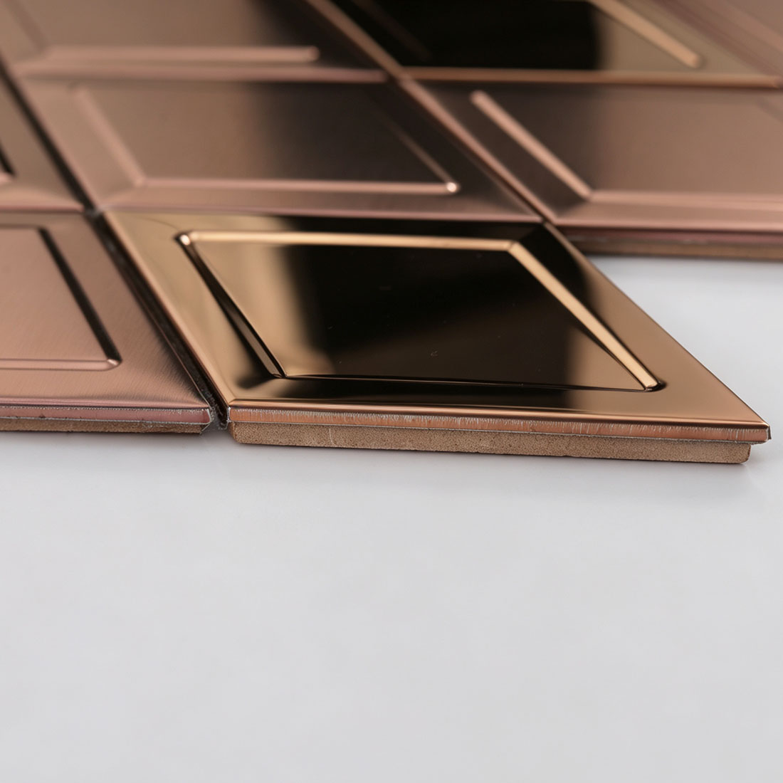 Side view of rose gold rhombus metal mosaic showing tile thickness