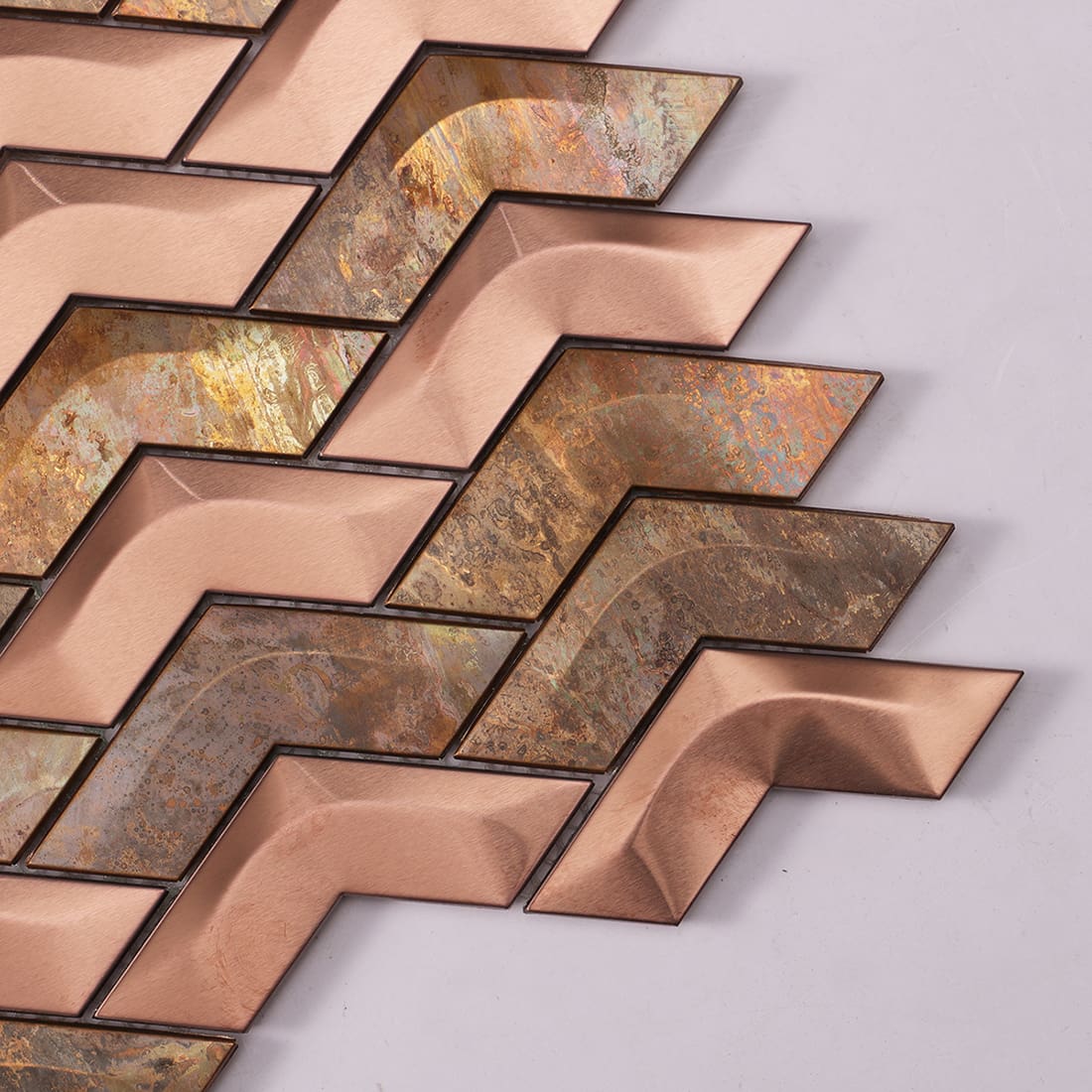 Corner detail of rose gold and rust chevron metal mosaic tile