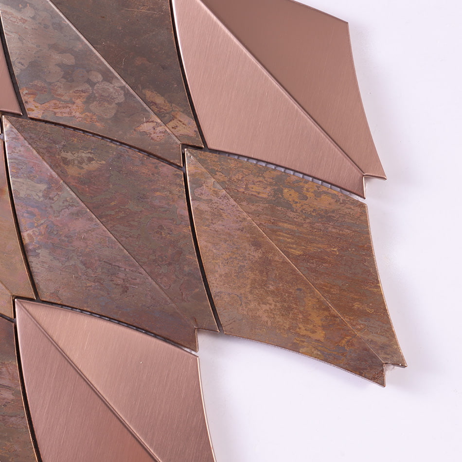 Edge detail of rose gold and rustic copper curved diamond metal mosaic tile