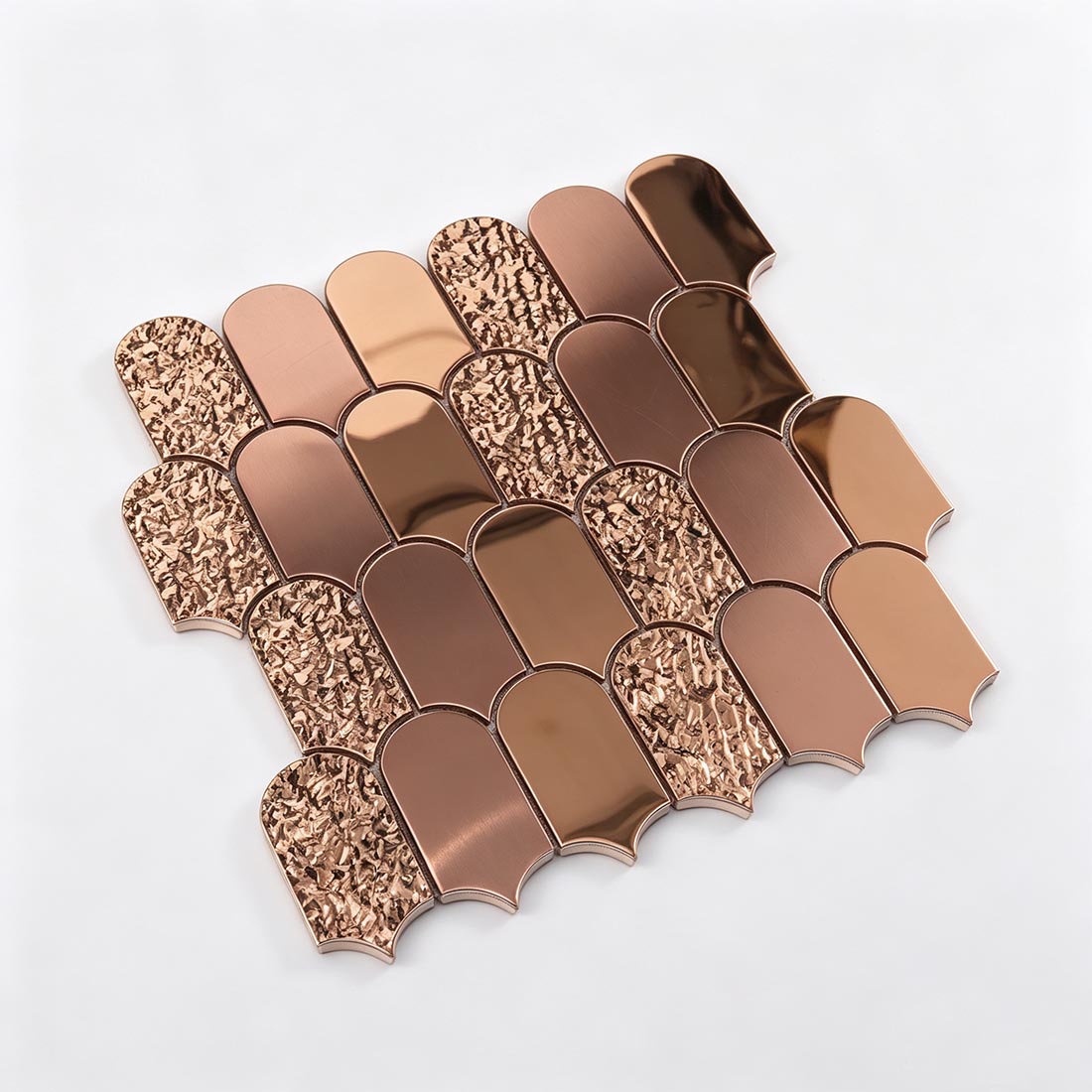 Angled perspective view of rose gold scallop metal wall mosaic tile sheet
