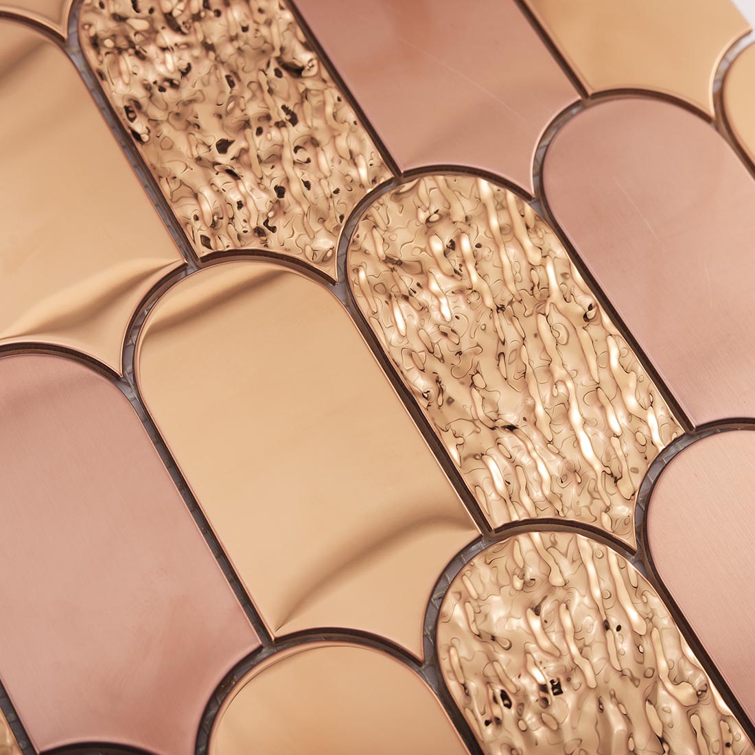 Top view showing water ripple texture on rose gold scallop stainless tile
