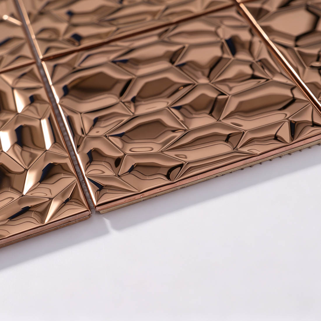 Edge and corner detail of rose gold square 3D metallic mosaic