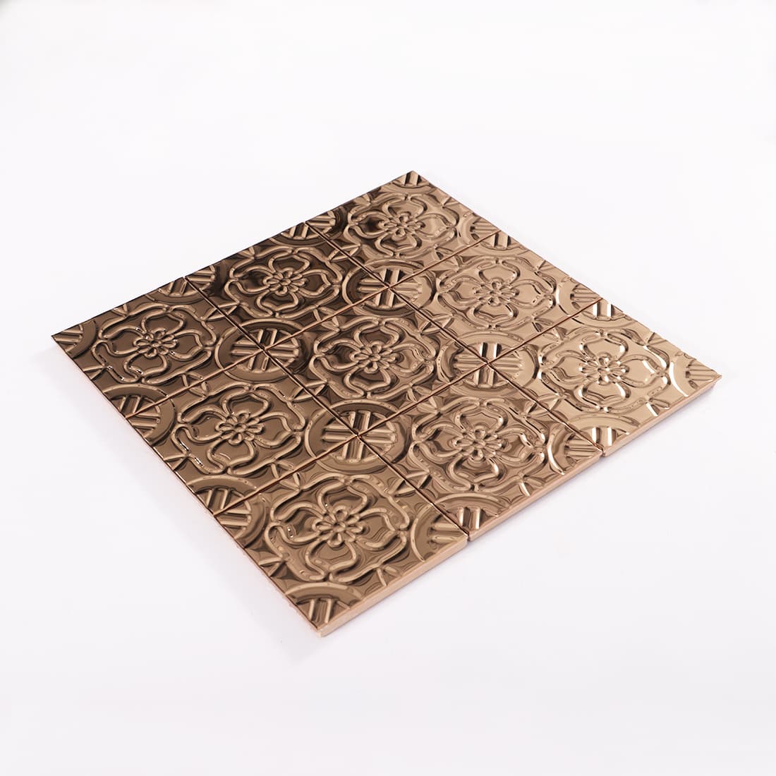 Angled view of rose gold stainless steel embossed floral mosaic sheet