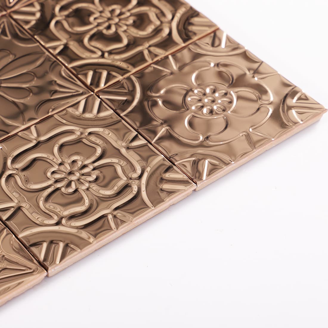 Side view of rose gold stainless steel embossed mosaic tiles showing thickness