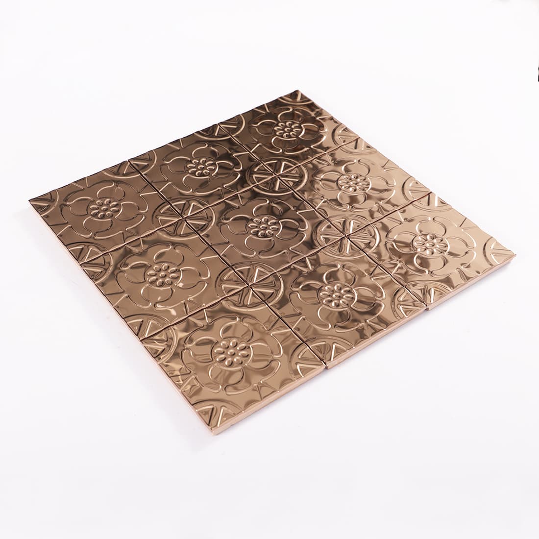 Angled view of rose gold stainless steel floral embossed mosaic sheet