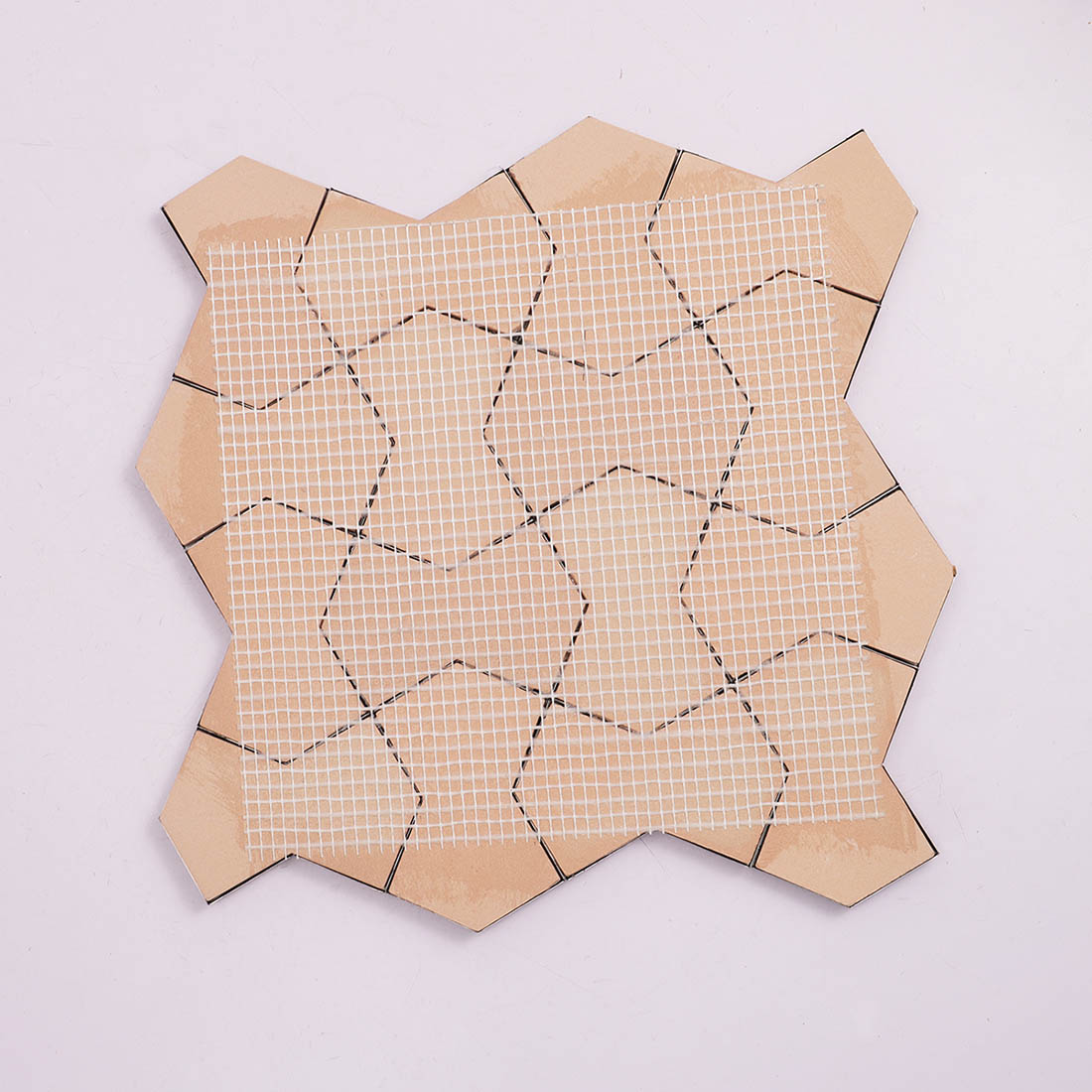 Back view of rose gold star metal mosaic tile sheet with mesh backing