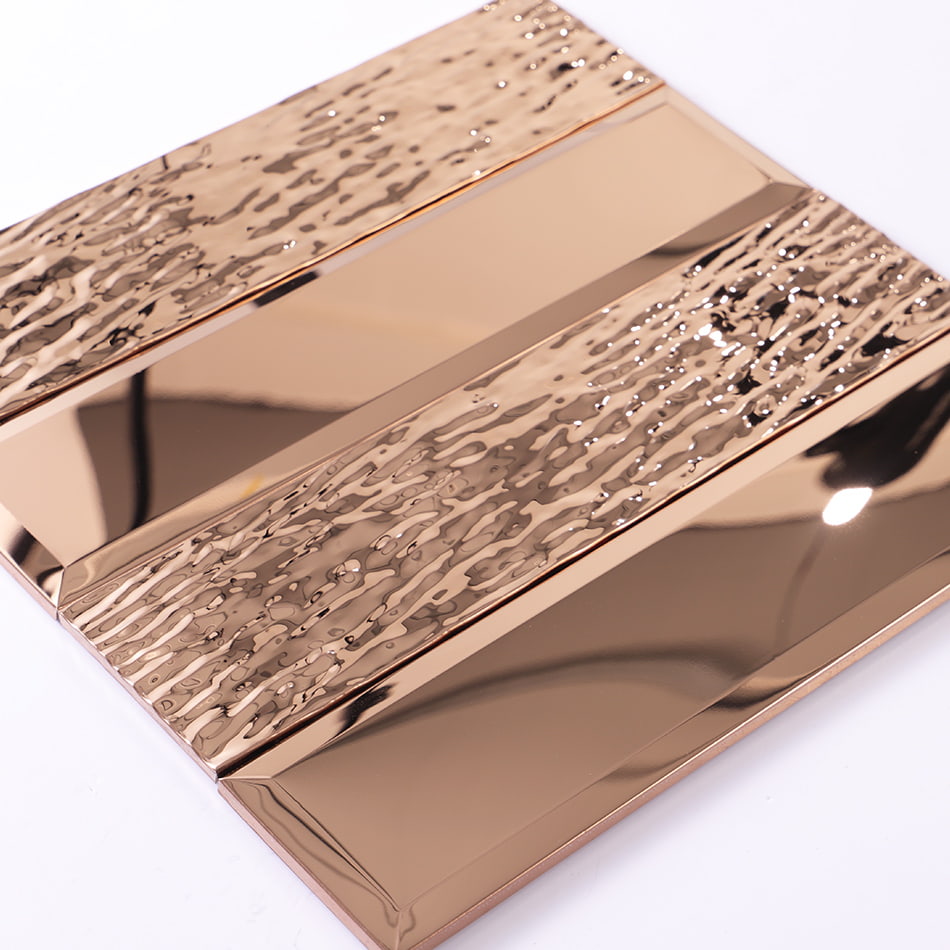 Angled view of rose gold beveled textured metal mosaic tile
