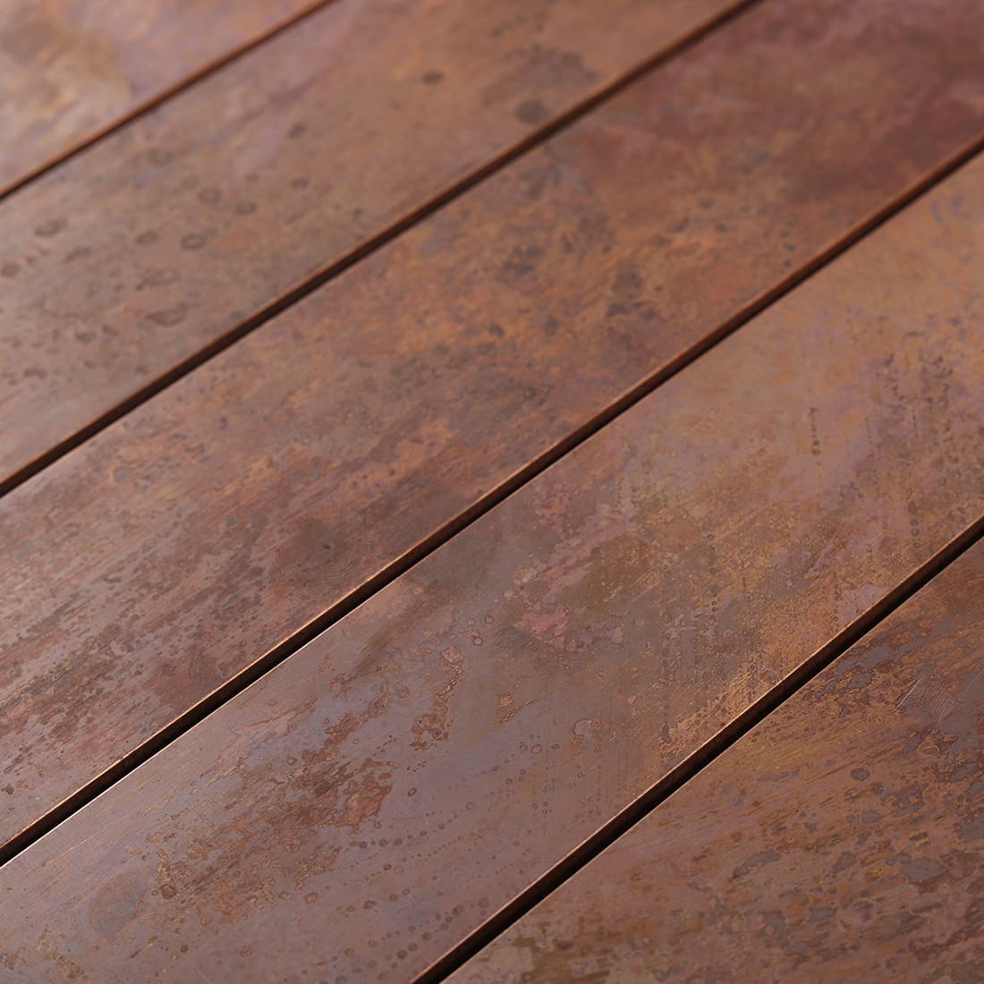 Rustic copper rectangular metal tile detail with mottled aged surface