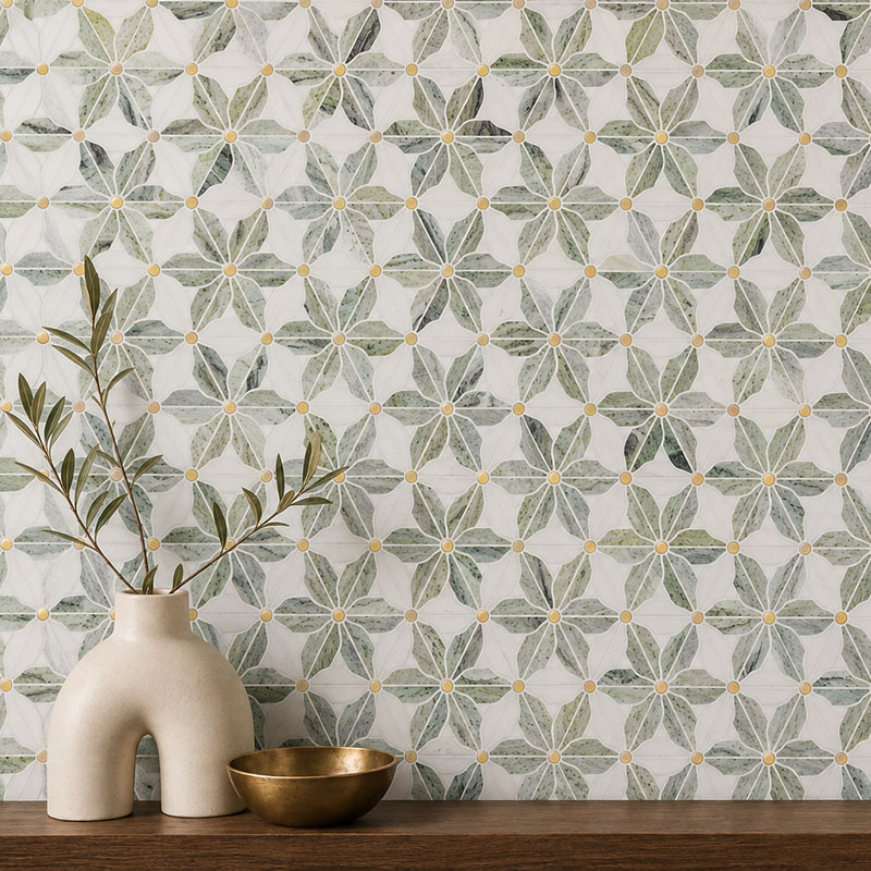 Sage green floral bohemian tiles on a feature wall with a ceramic vase and brass bowl