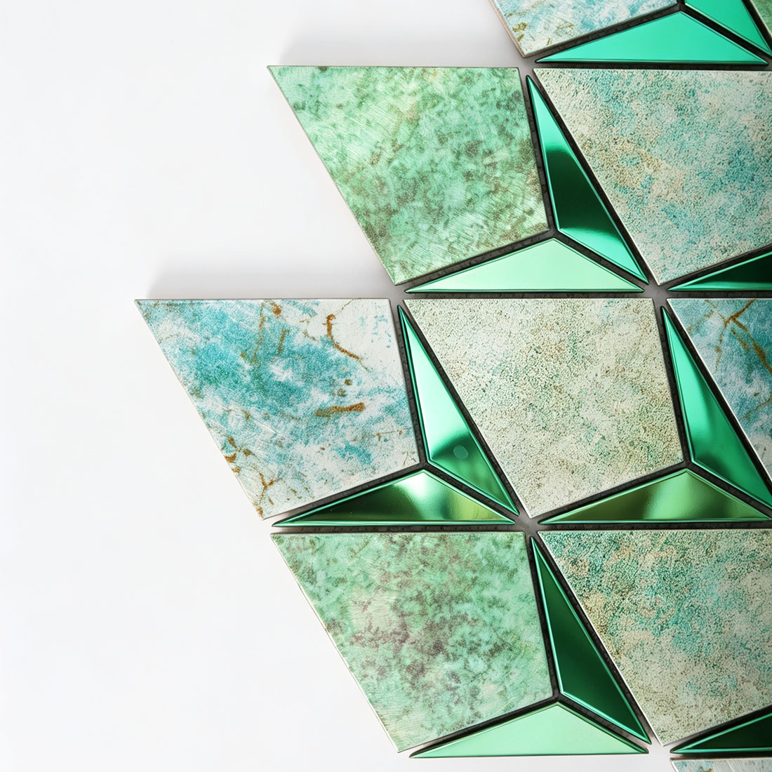 Close-up of seafoam green marble effect metal mosaic with polished emerald accents