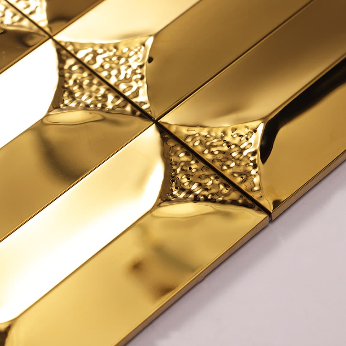 Side profile showing the 3D depth of gold beveled metal tiles.