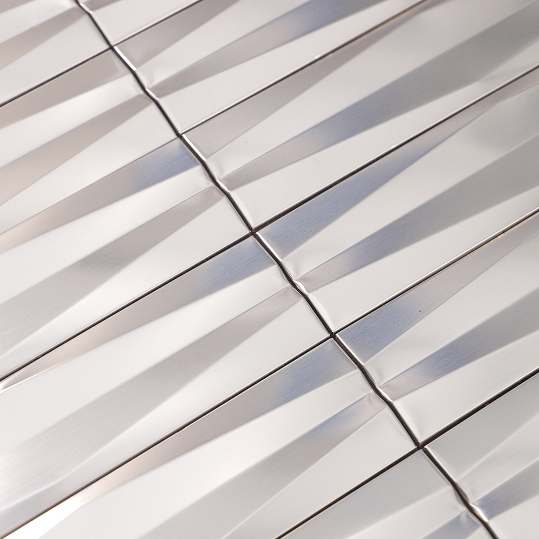 Detailed view of silver 3D linear stainless steel mosaic tile surface