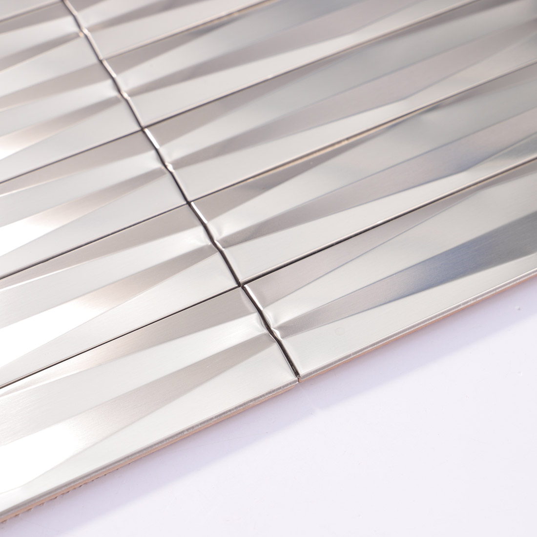 Edge detail of silver 3D linear stainless steel mosaic tile sheet