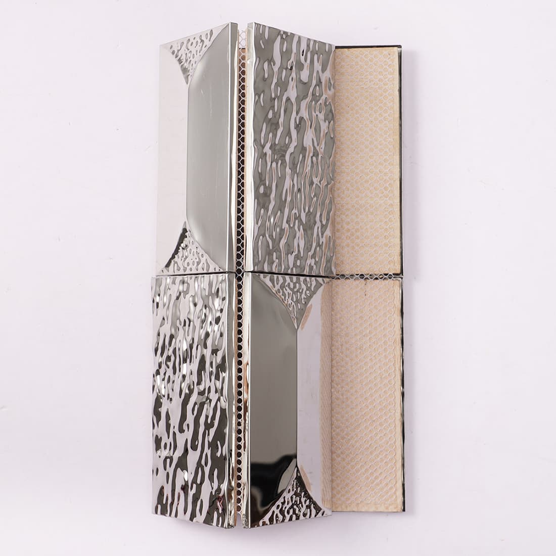 Partial sheet of silver 3D tiles showing the fiber mesh backing.