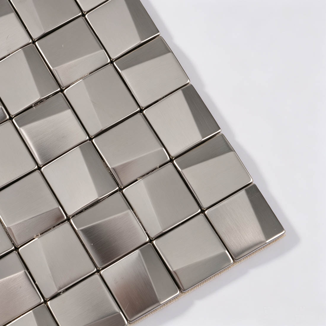 Close-up of silver 3D square stainless steel mosaic tile corner
