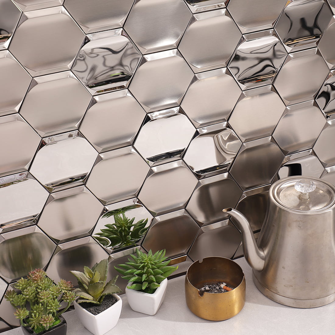 Silver brushed and mirror hexagon stainless steel backsplash with kettle and plants
