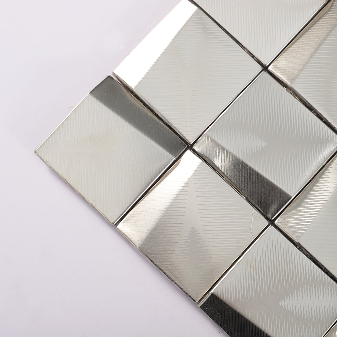 Corner detail of silver brushed square metal mosaic tiles