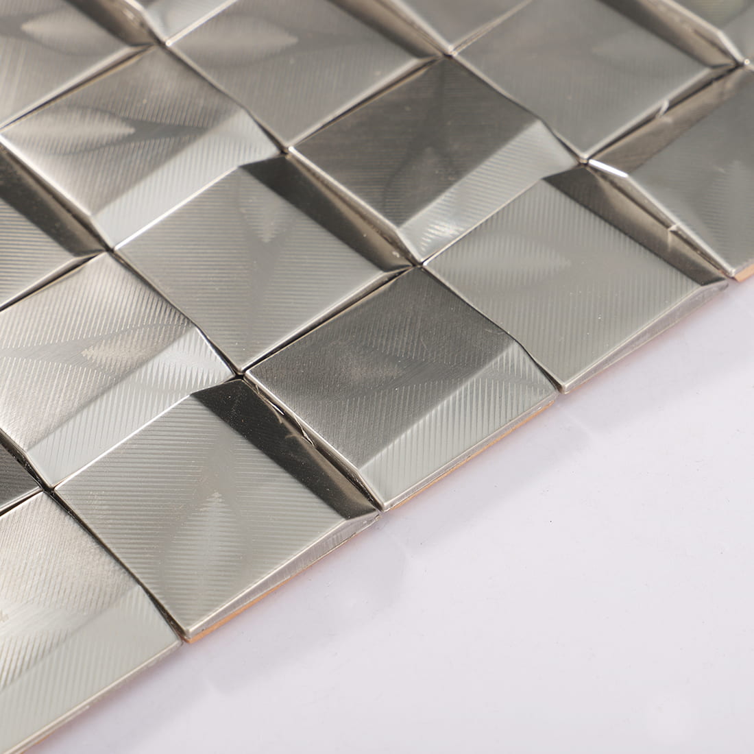 Edge detail of silver brushed square metal mosaic tile sheet