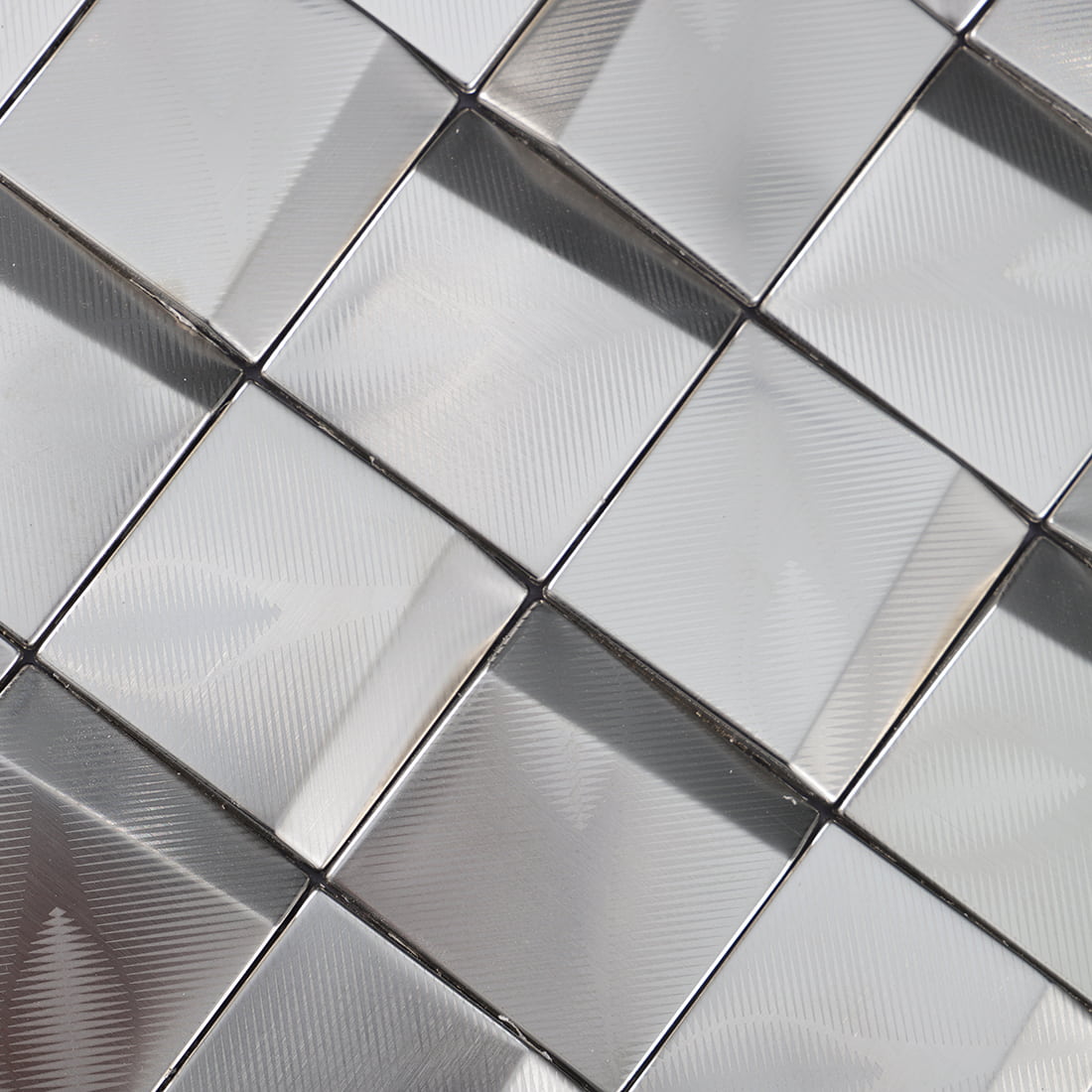 Close-up of silver brushed square metal mosaic tile surface