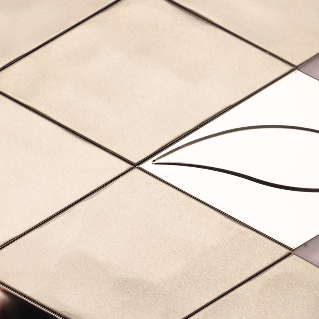 Close up of silver diamond tiles with mixed brushed and mirror textures.