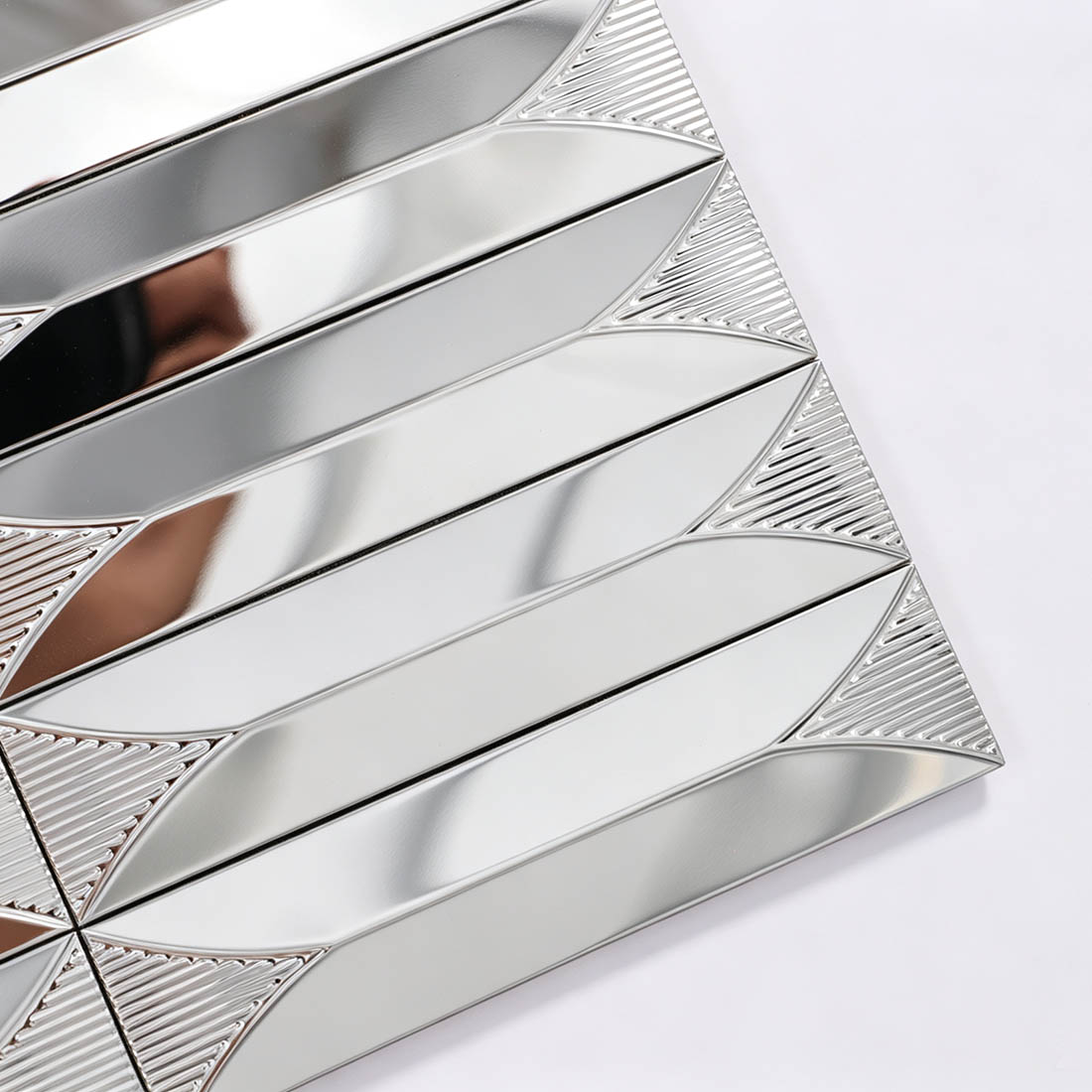 Close-up of silver elongated leaf stainless steel mosaic tile corner