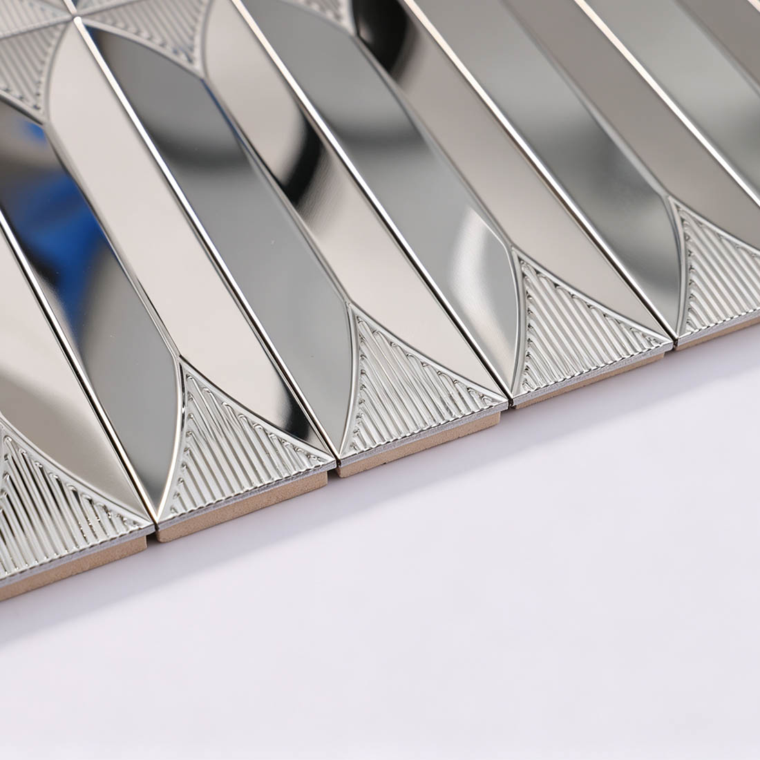 Edge detail of silver elongated leaf stainless steel mosaic tile sheet