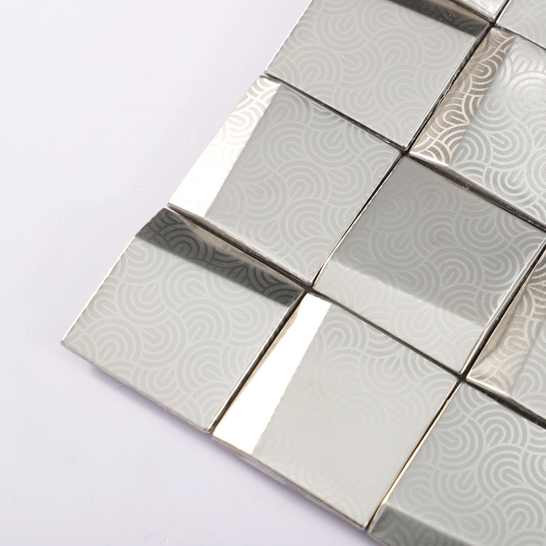 Corner detail of silver embossed square metal mosaic tiles