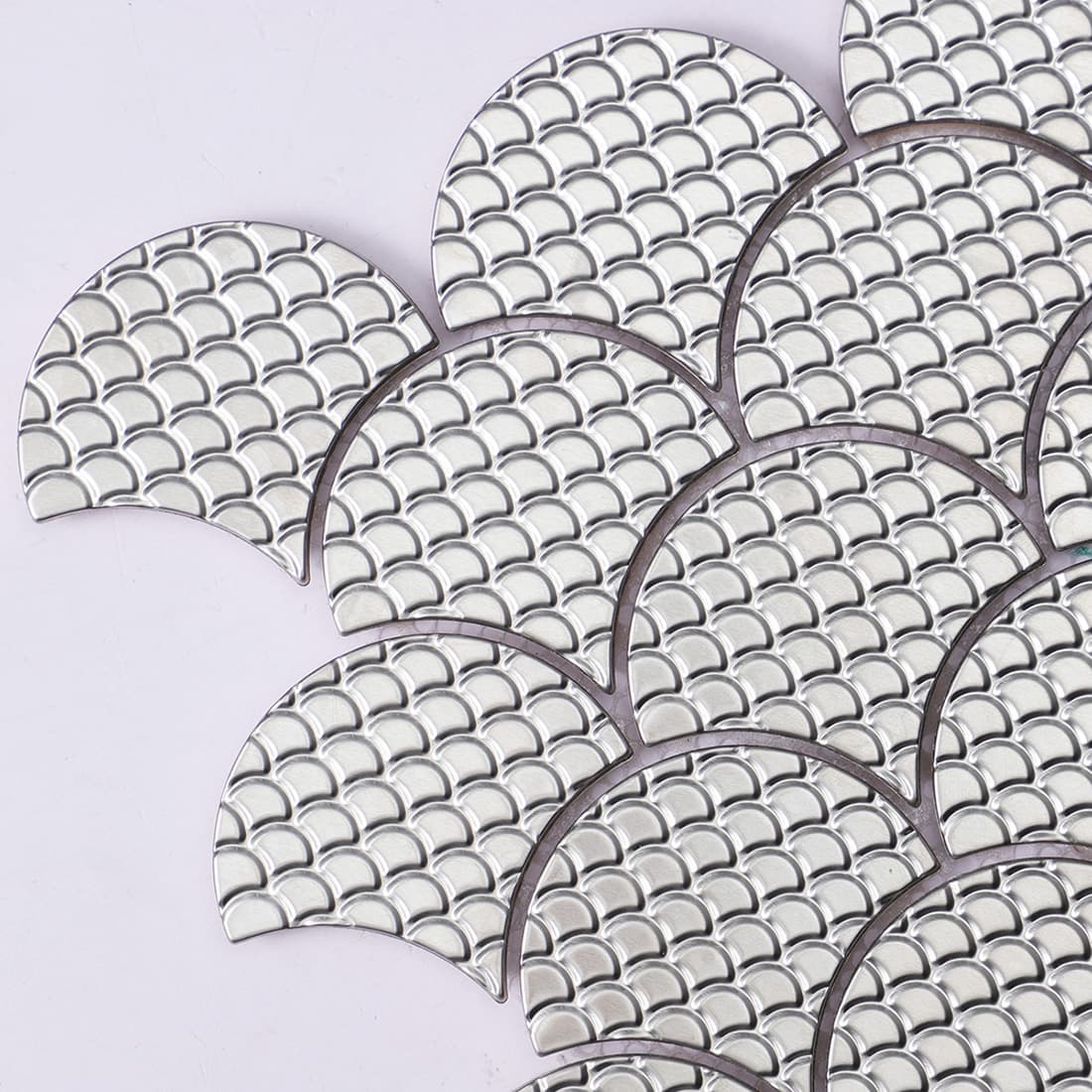 Close-up of silver fish scale metal mosaic tile surface