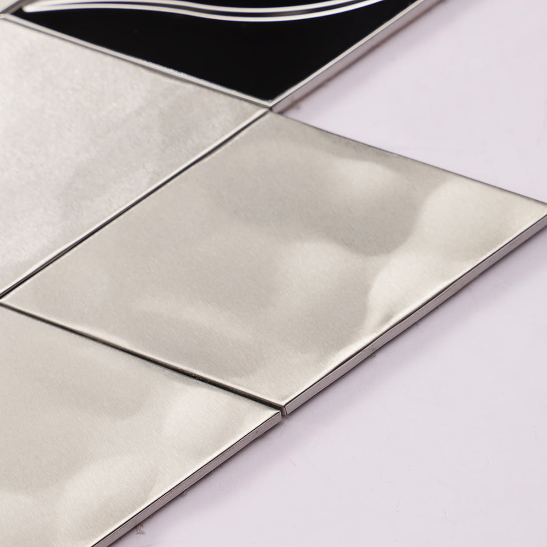 Macro view of a silver diamond metal tile with a hammered texture.