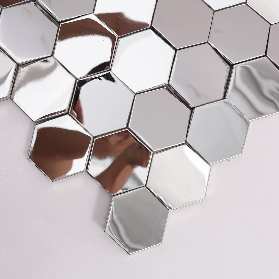 Close-up of silver hexagon mirror metal mosaic tiles with polished shine