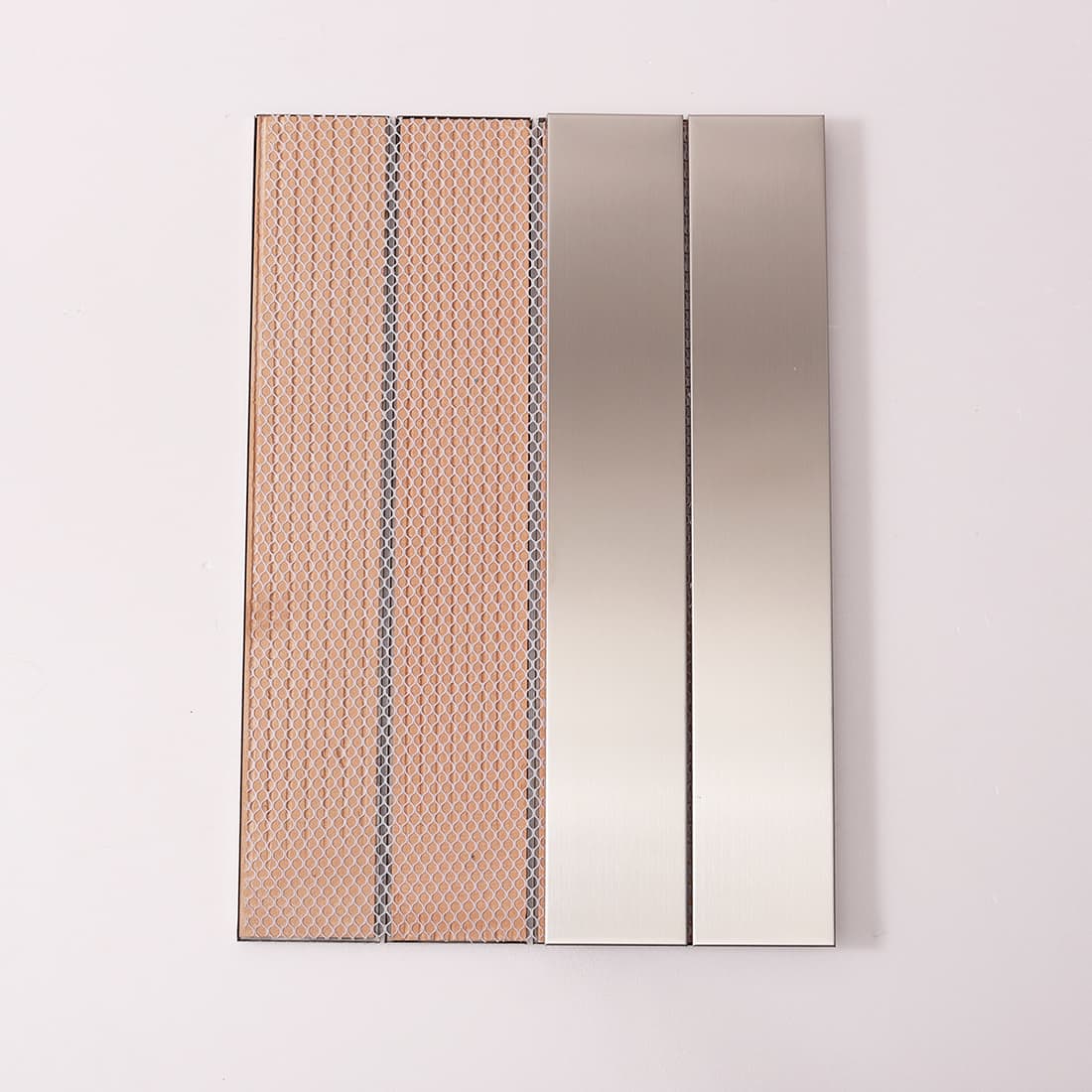 Front and back of silver linear tiles showing mesh installation backing.