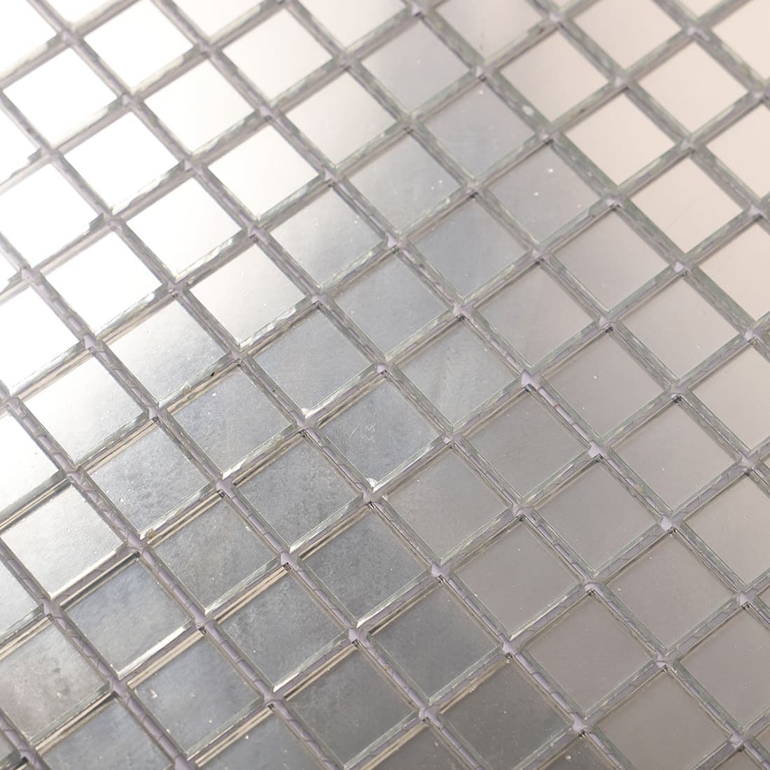 Close-up of silver mirror 20mm square glass mosaic tile surface