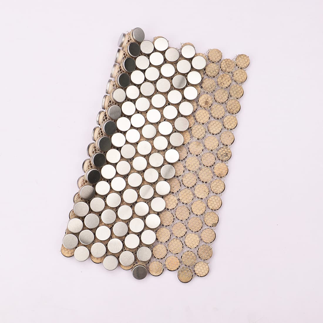 Silver penny round metal mosaic partially lifted to show mesh backing