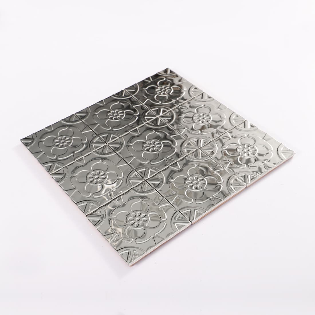 Angled view of silver stainless steel floral embossed mosaic sheet