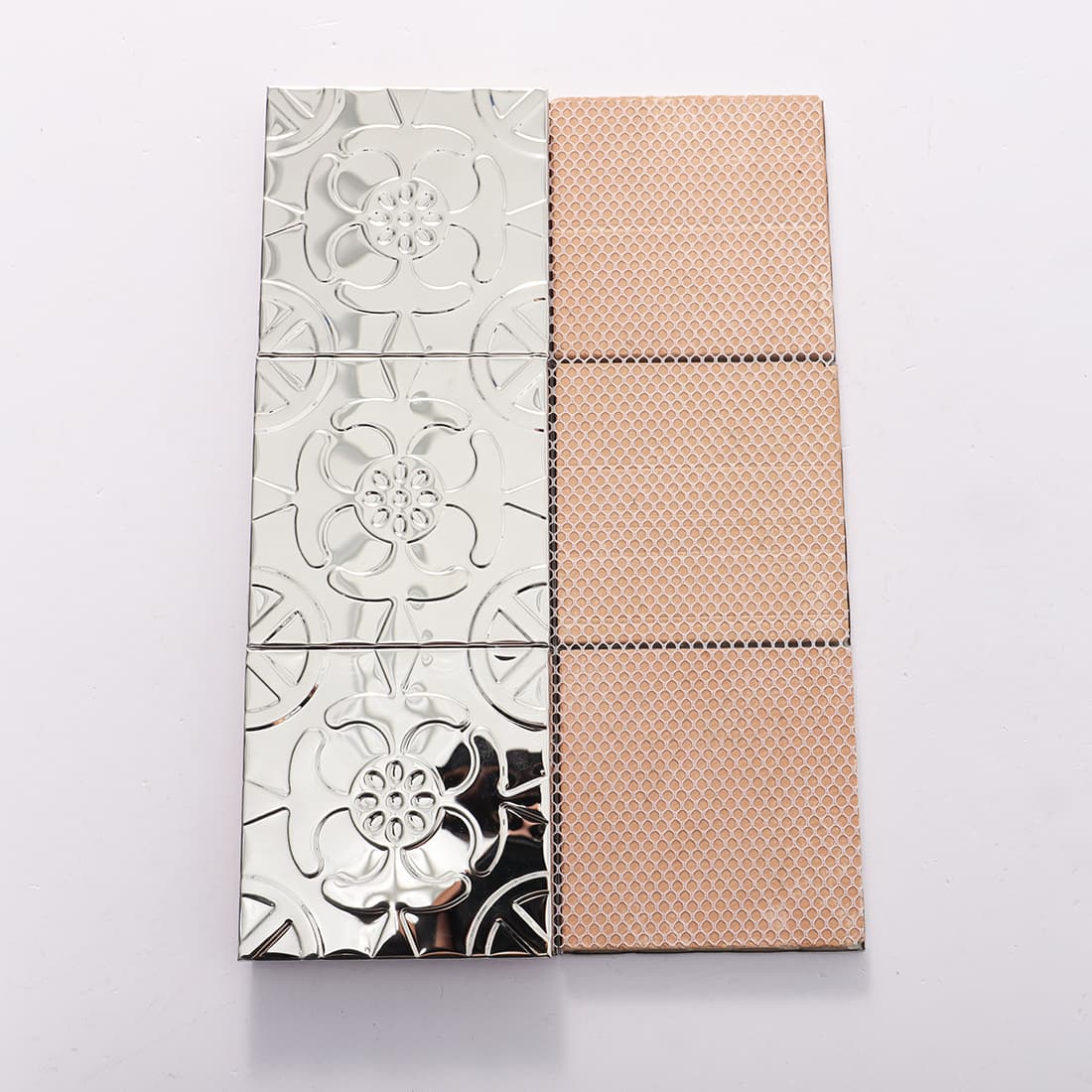 Front and mesh back view of silver stainless steel floral embossed tiles