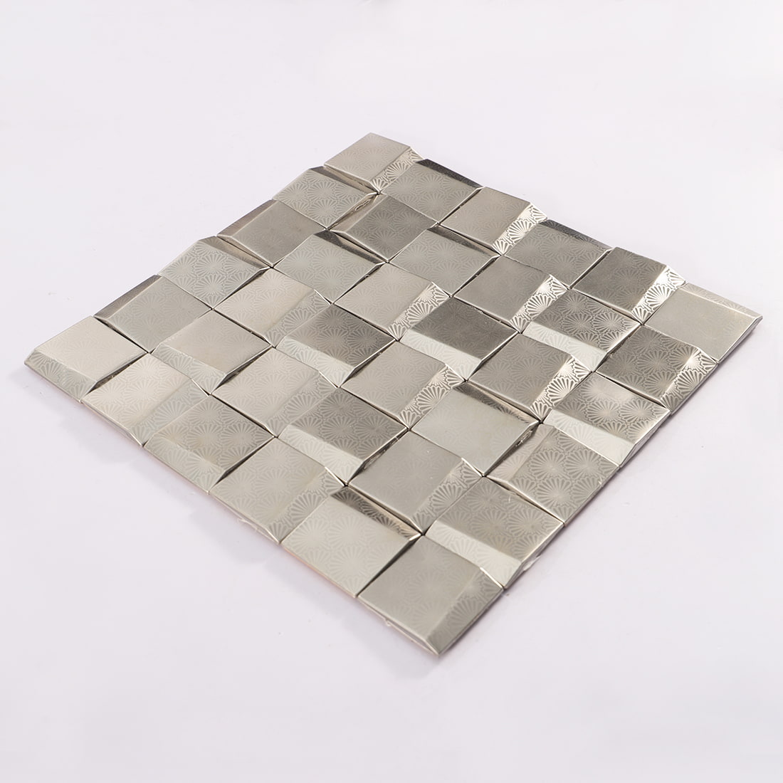 Angled view of silver stainless steel pyramid square mosaic tile