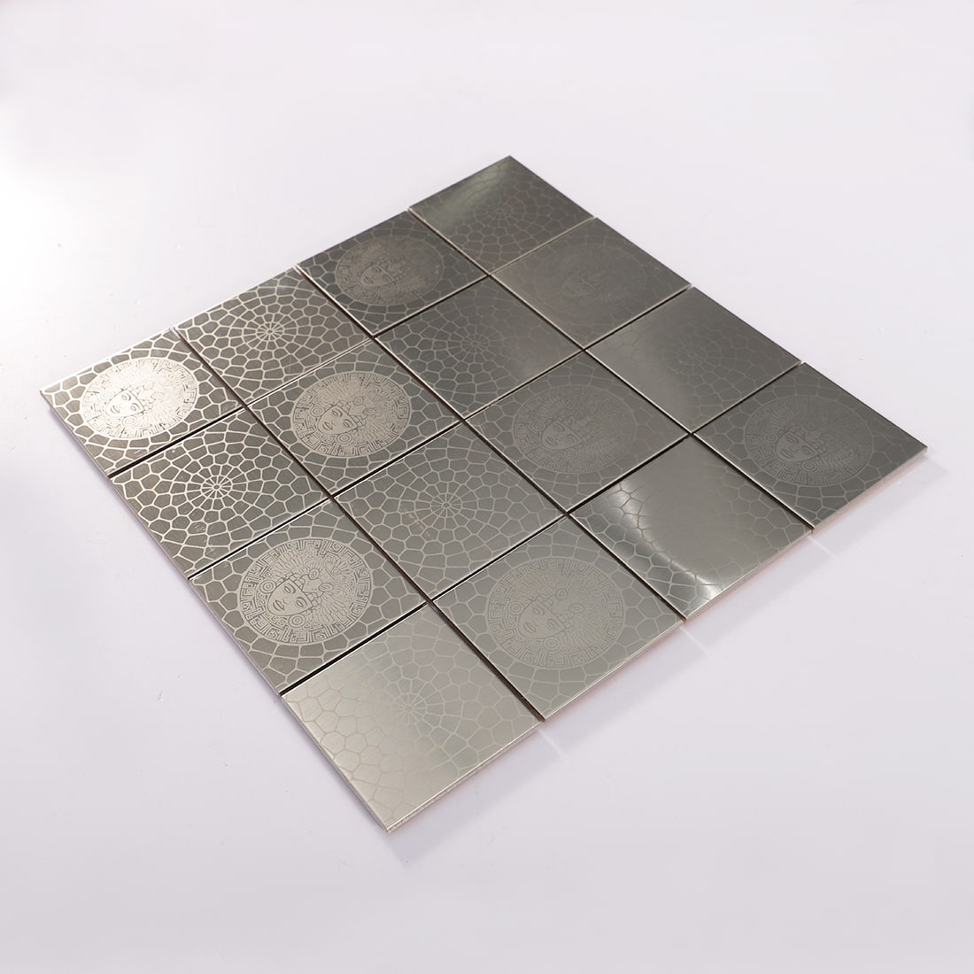 Angled view of silver stainless steel square mosaic tile sheet