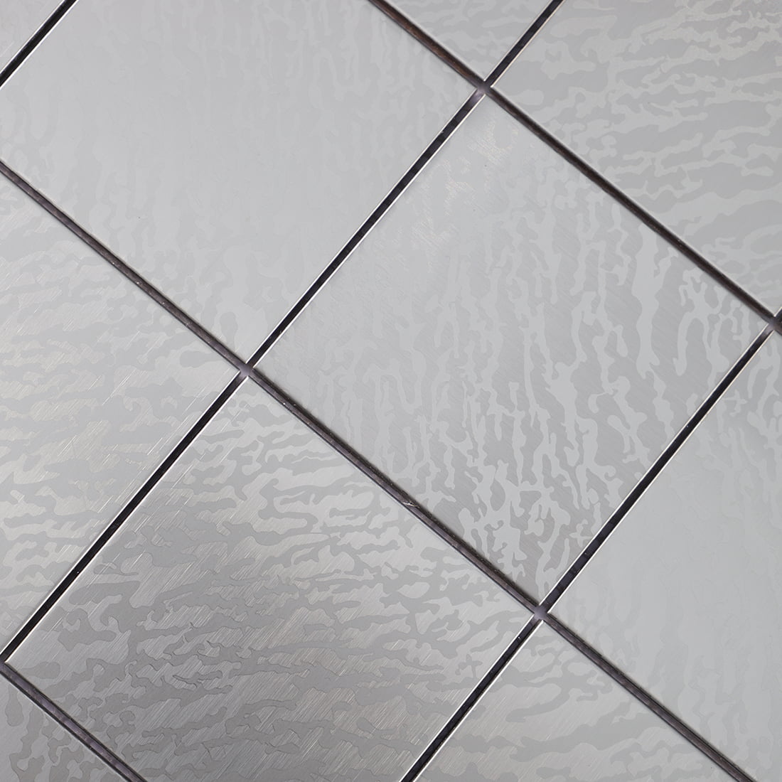 Detail of silver stainless steel square tile with flowing texture pattern