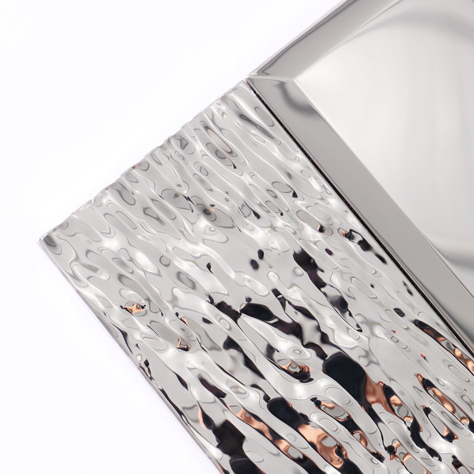 Corner detail of silver textured metal mosaic tile with hammered finish