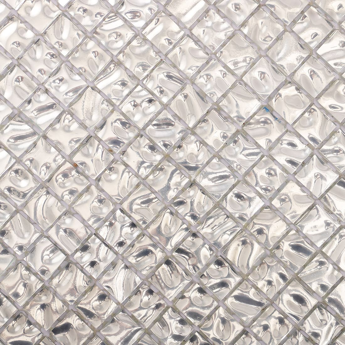Close-up of silver wavy 15mm square glass mosaic tile surface