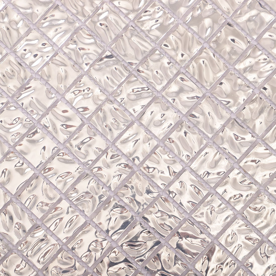Close-up of silver wavy 20mm square glass mosaic tile surface