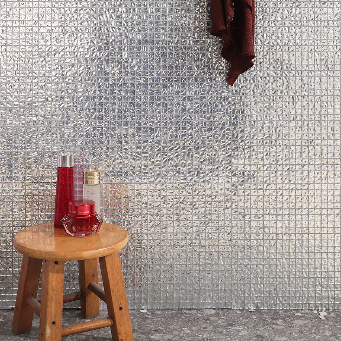 Silver wavy square glass mosaic wall tile in interior scene with folding chair