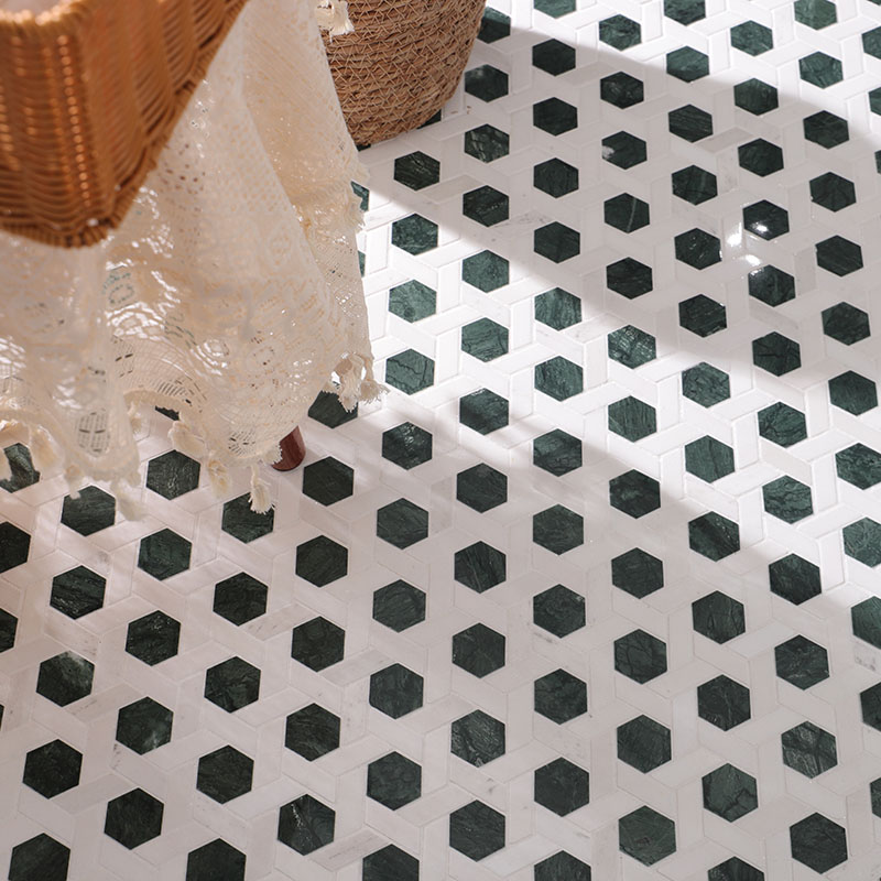 Close-up of small hexagon dark green marble tiles with white grout