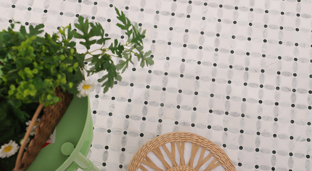 {"default":"Small marble tiles in white oval mosaic pattern with black dot accents"}
