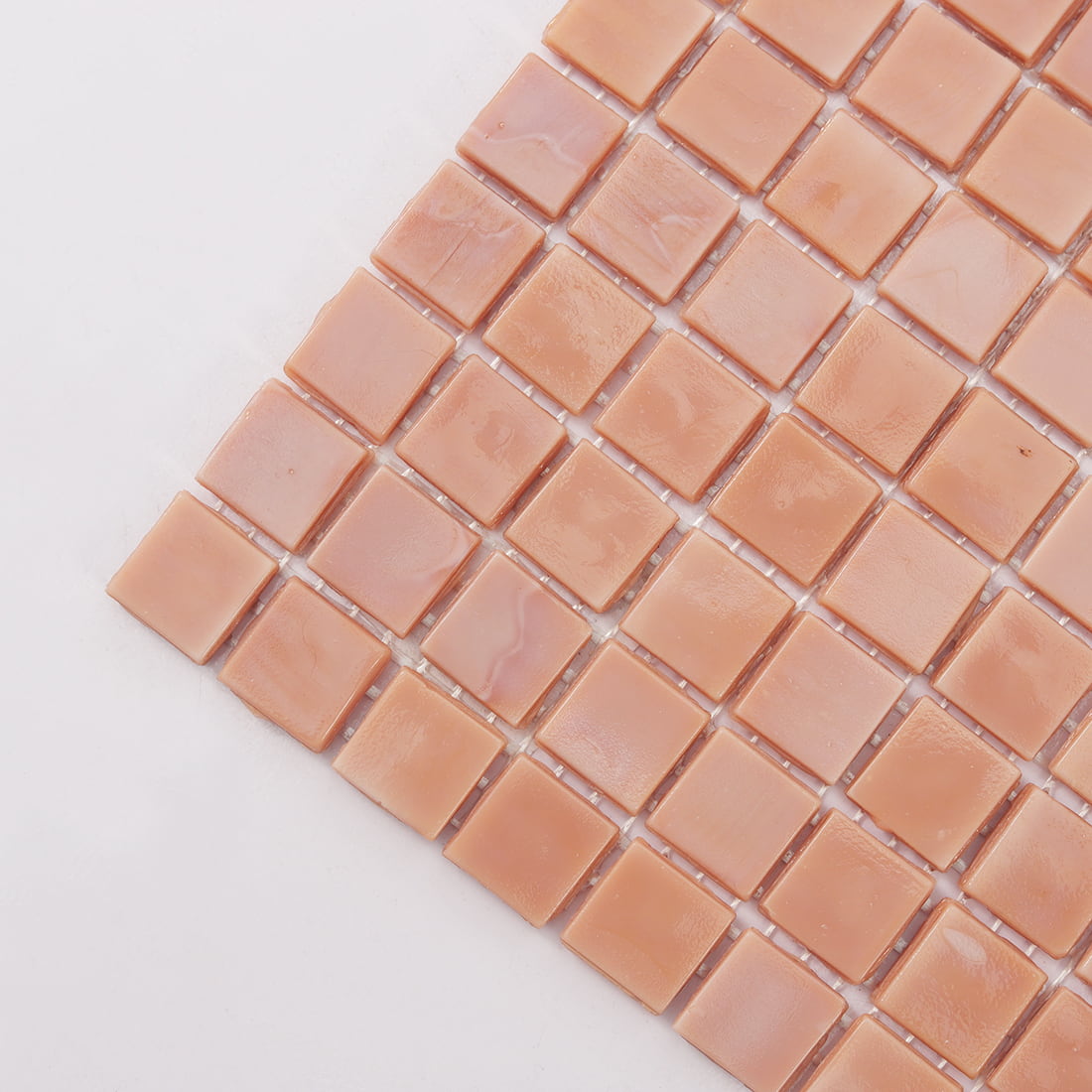 Corner detail of soft pink square glass mosaic tile